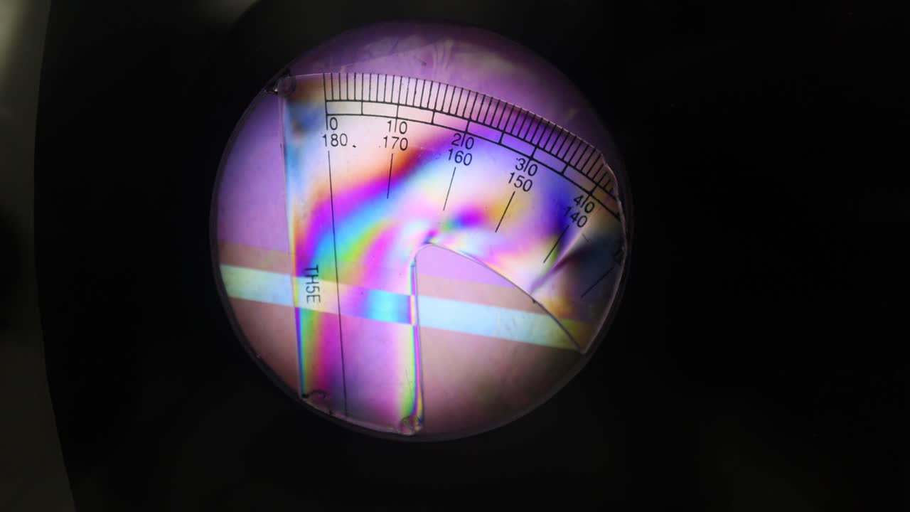 Colorful light patterns on a protractor surface