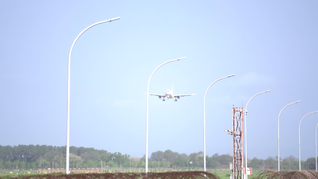 atmosphere of the runway of Yogyakarta International Airport, seen a Transnusa commercial plane landing.