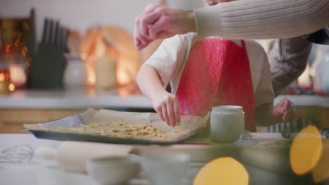 dad and son prepare sweet holiday pastries