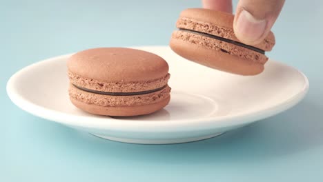 chocolate macarons on a white plate