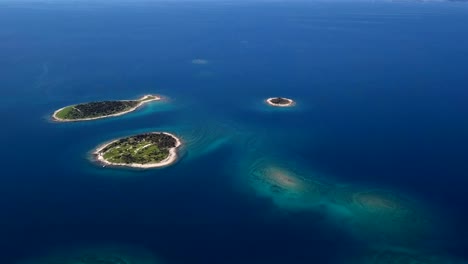 flight over small desert islands and colorful sea, brijuni park, croatia.