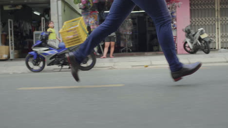 man in suit running down road