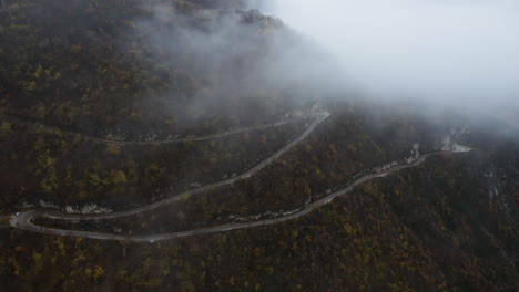 aerial view of the mountain serpentine road in kotor, montenegro on a foggy day