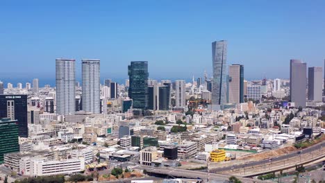 panoramic aerial view of a modern city skyline with skyscrapers and highway