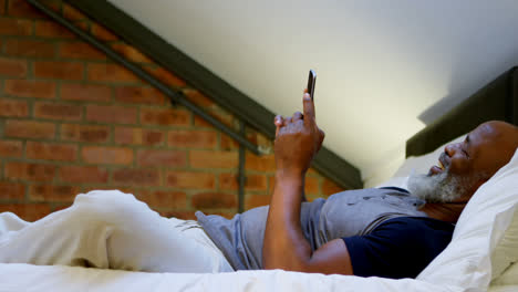 senior man using mobile phone in bedroom 4k