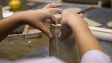 student creating pottery