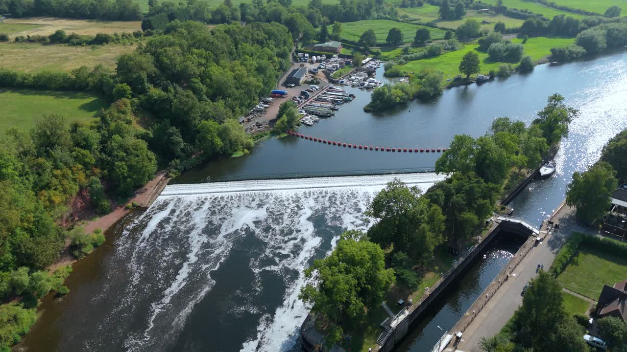Aerial drone sunset over Gunthorpe Weir and River Trent Nottinghamshire with navigation canal and rural green English countryside landscape summer evening