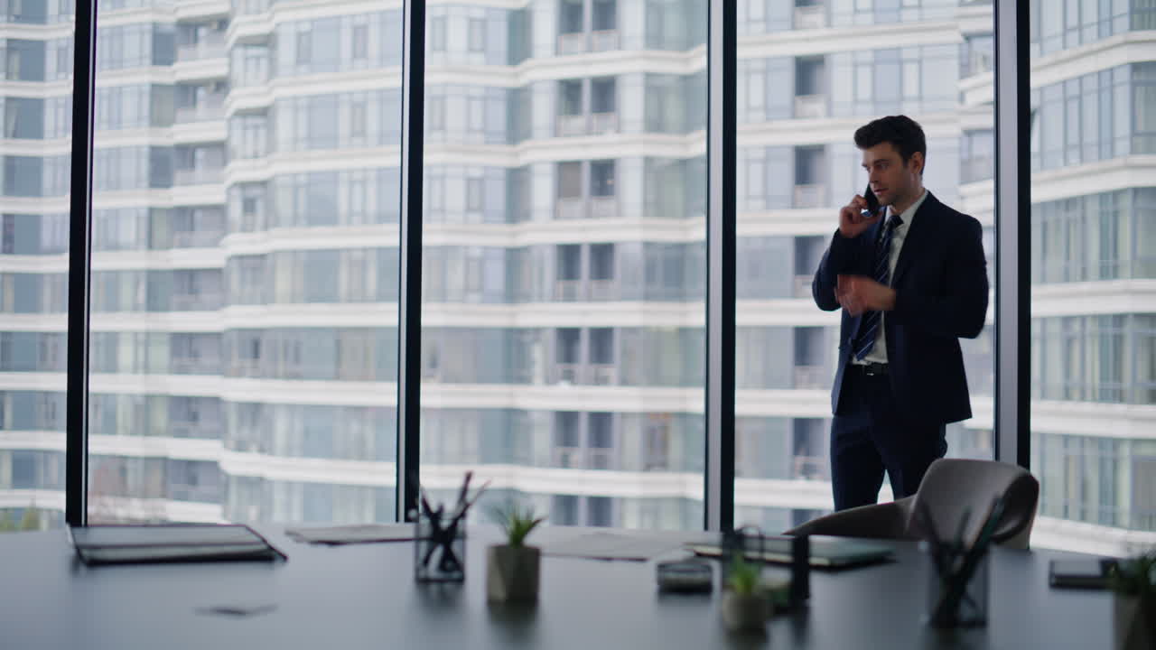 Executive discussing business mobile phone call standing company office