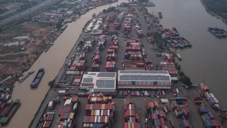 hyperlapse over saigon river container port in ho chi minh city, vietnam with interesting activity of moving vehicles, boats, and cranes