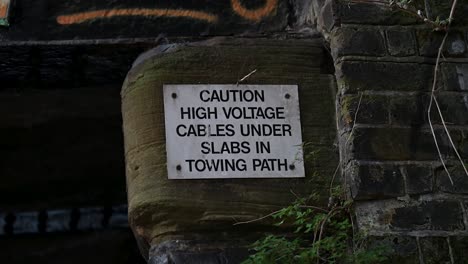 caution, there are high voltage cables under slabs in the towing path, camden, london, united kingdom