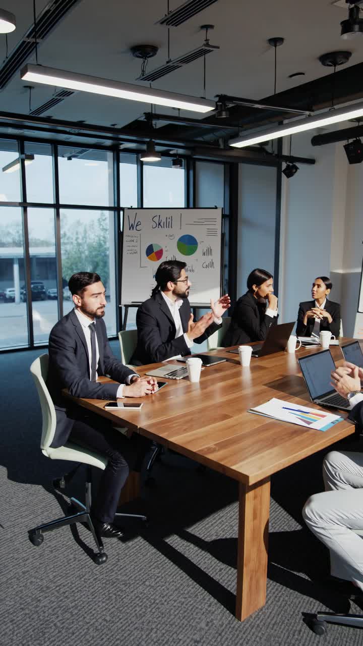 A high-angle video shot of a business meeting in a modern office