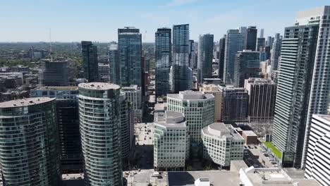 Drone-flying-through-buildings-in-downtown-Toronto-on-a-sunny-spring-day