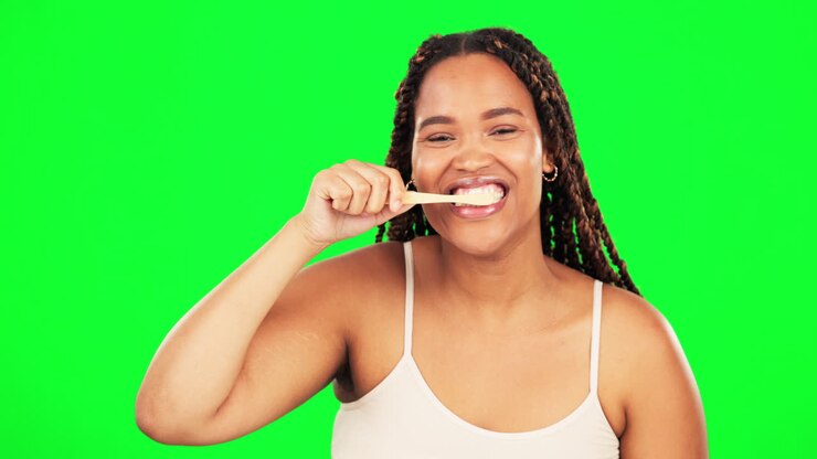 Green screen, face and happy woman brushing teeth