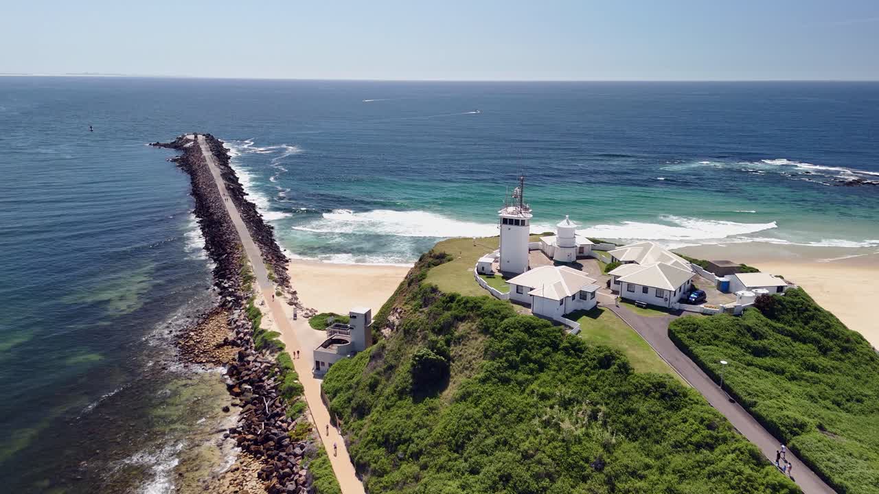 Flyover Nobbys lighthouse at entrance to Newcastle NSW harbour, AUS