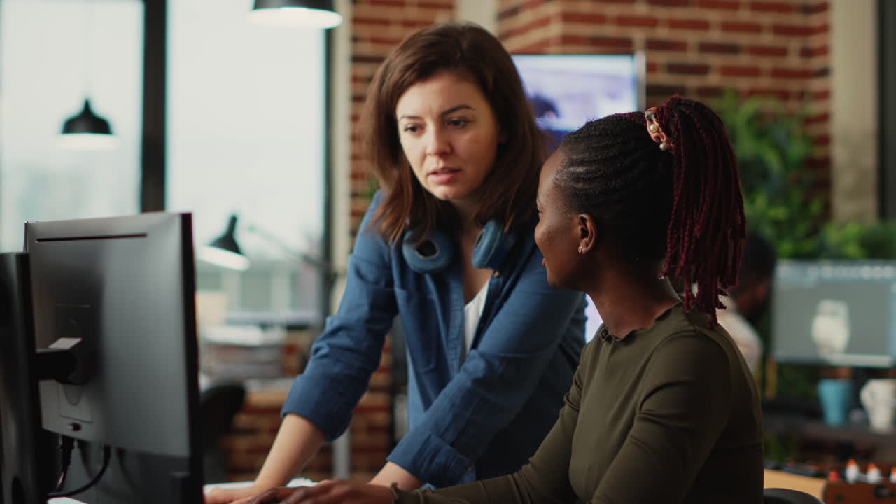 Team of diverse office employees working on multi monitors