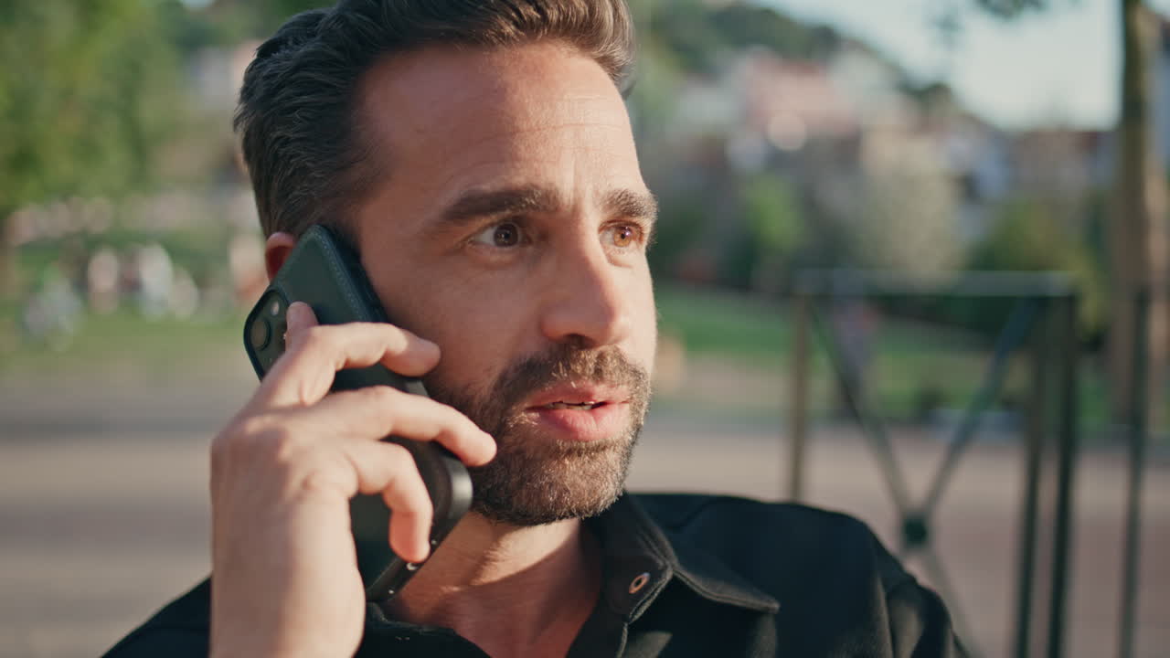 Emotional guy speaking smartphone call sunshine park closeup.  man calling