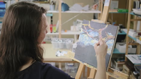 woman painting in art studio