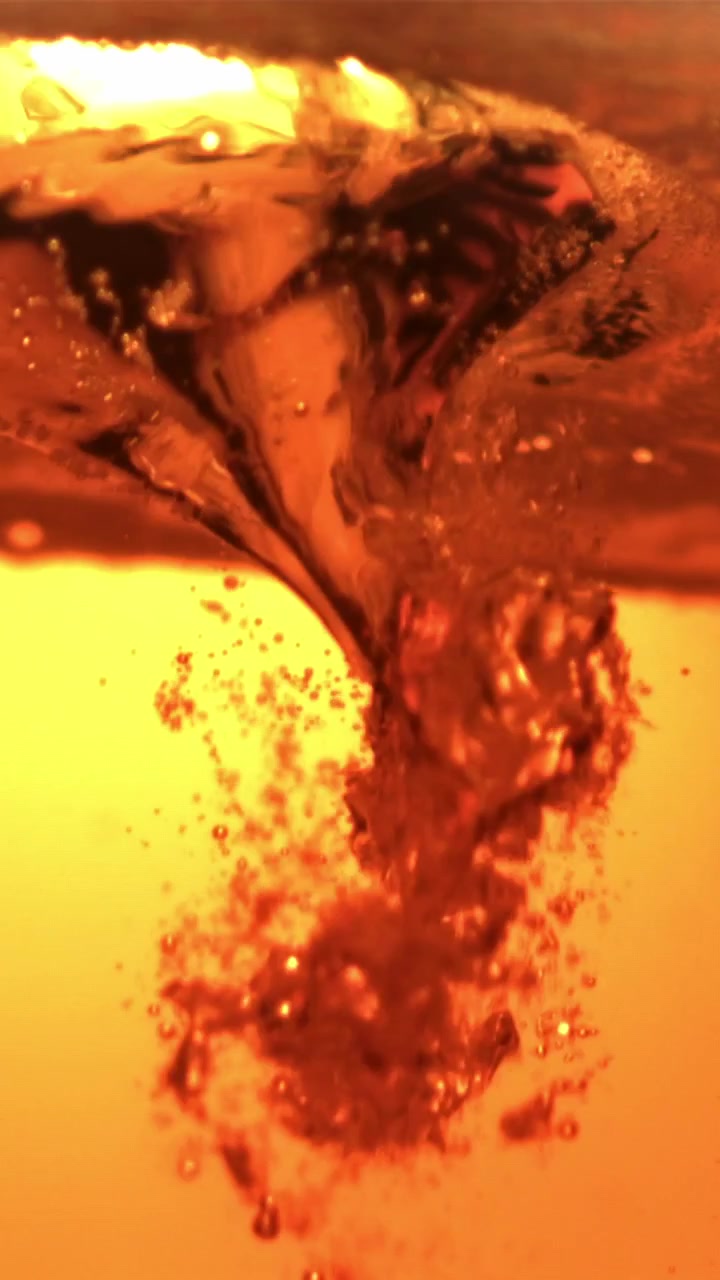 Macro Close-up of Golden Liquid with Rising Bubbles
