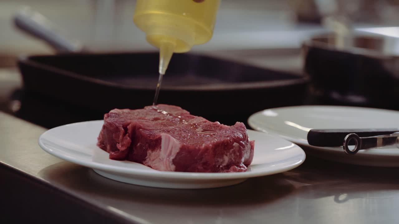 Close up : Marinating steak with oil. steak on a plate marinating with some oil