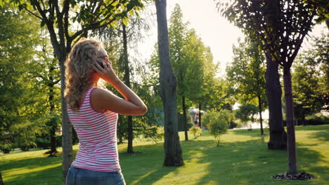 a young attractive woman walks in a well-groomed park on a summer day 5