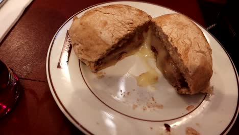 handheld closeup view of a prego, traditional sandwich dish in porto