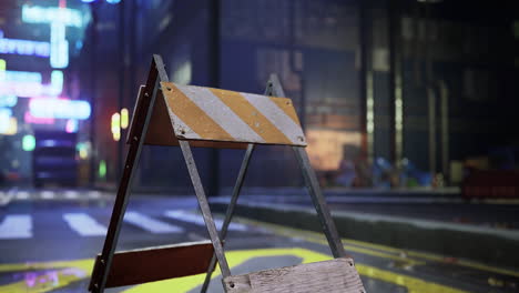 construction barrier denotes ongoing road work in busy urban area at night