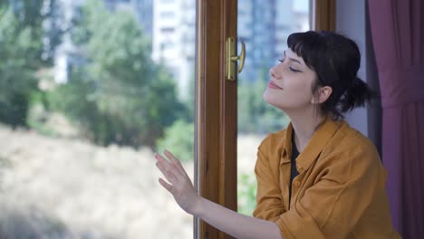 the young woman looking out the window.