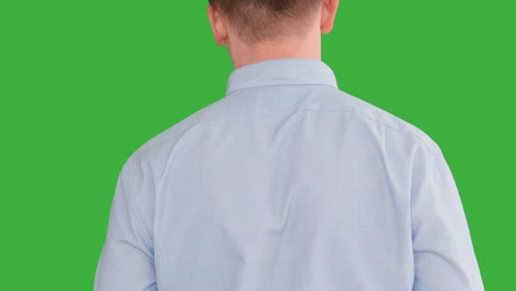 young caucasian man standing against green screen background. male person isolated on chroma key. casual business professional portrait