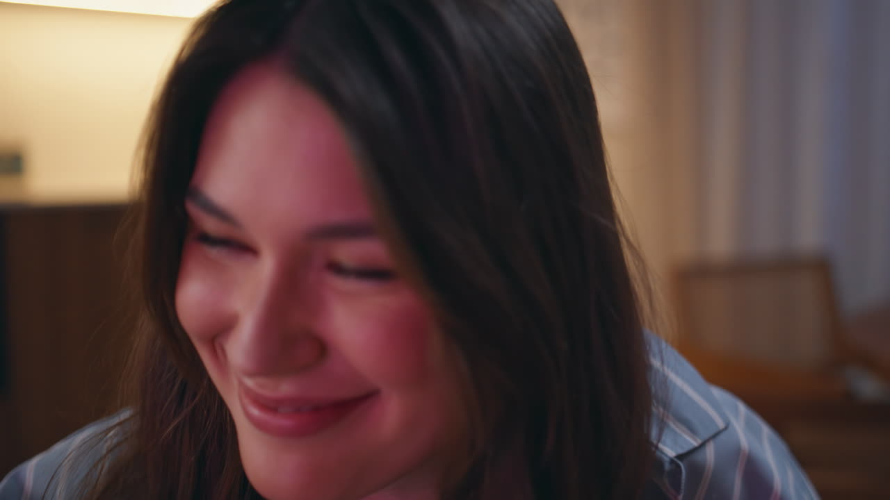 Young woman eating popcorn watching tv with unknown friends evening home closeup
