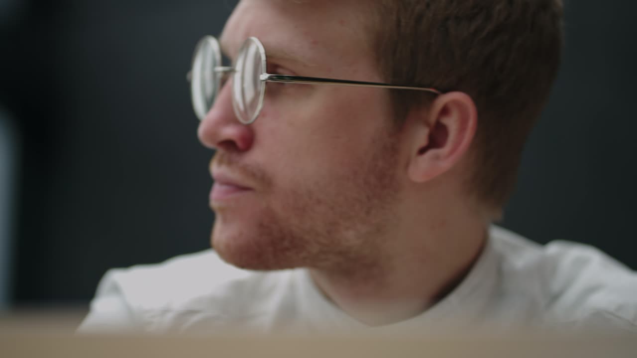 retrato de un hombre cansado y pensativo mirando la pantalla de una computadora portátil con gafas. un hombre de lluvia de ideas. resolución de problemas. pensar y trabajar