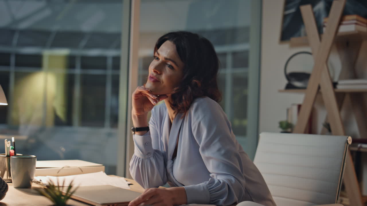 Smiling programmer finish work on computer at night office satisfied closeup
