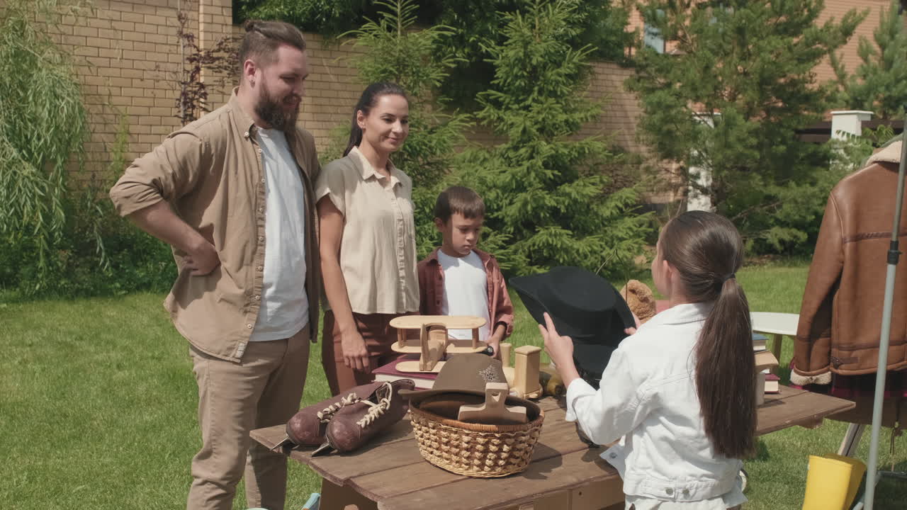 Happy Woman Trying on Hat at Yard Sale