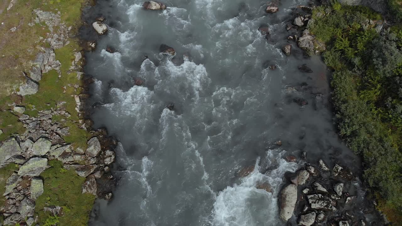 río de agua de deshielo glacial que fluye rápidamente aguas abajo en verano, noruega, vista aérea