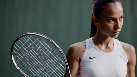 determined female tennis player in nike gear on court