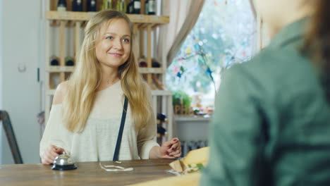 the seller at a small grocery store is talking to the buyer