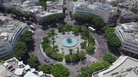 circling around dizengoff square, tel aviv at noon on a very hot summer day without many people and activity, people prefer to be in an air conditioned environment