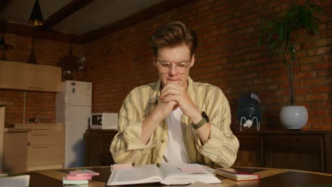 young man concentrating on studies at home