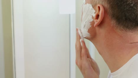 man applying shaving foam on his face 4k