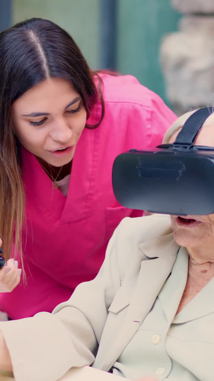 Elderly woman using VR with caretaker