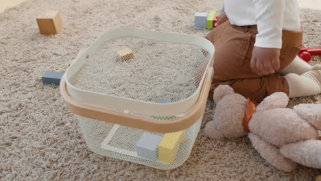 toddler putting toys away