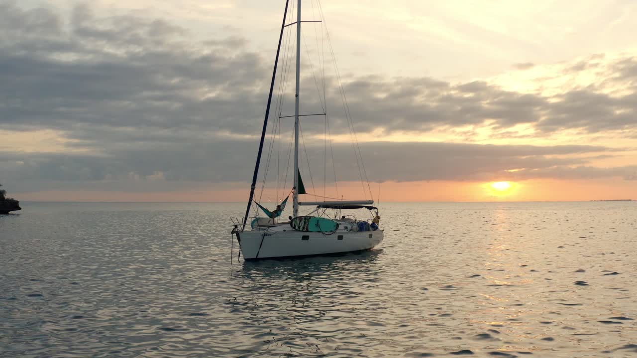 Floating Yacht With A Person On A Swing Enjoying Sunset View Of Bahamas In Florida. - Wide Shot