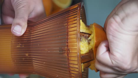 squeezing oranges with a juicer