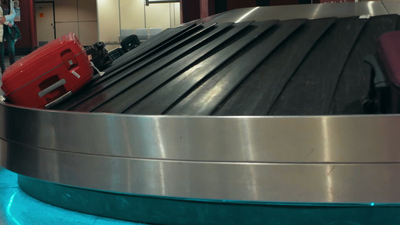 Suitcases on conveyor belt waiting for owners