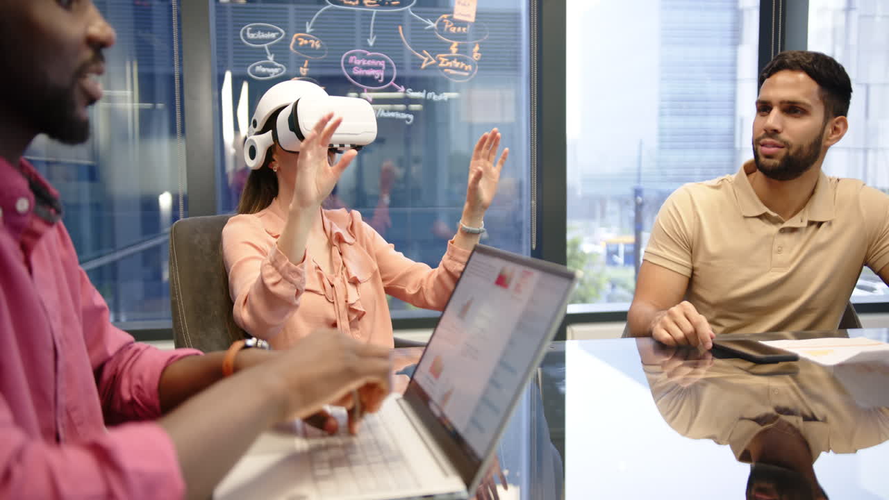 Using VR headset, woman interacting with virtual environment in office meeting
