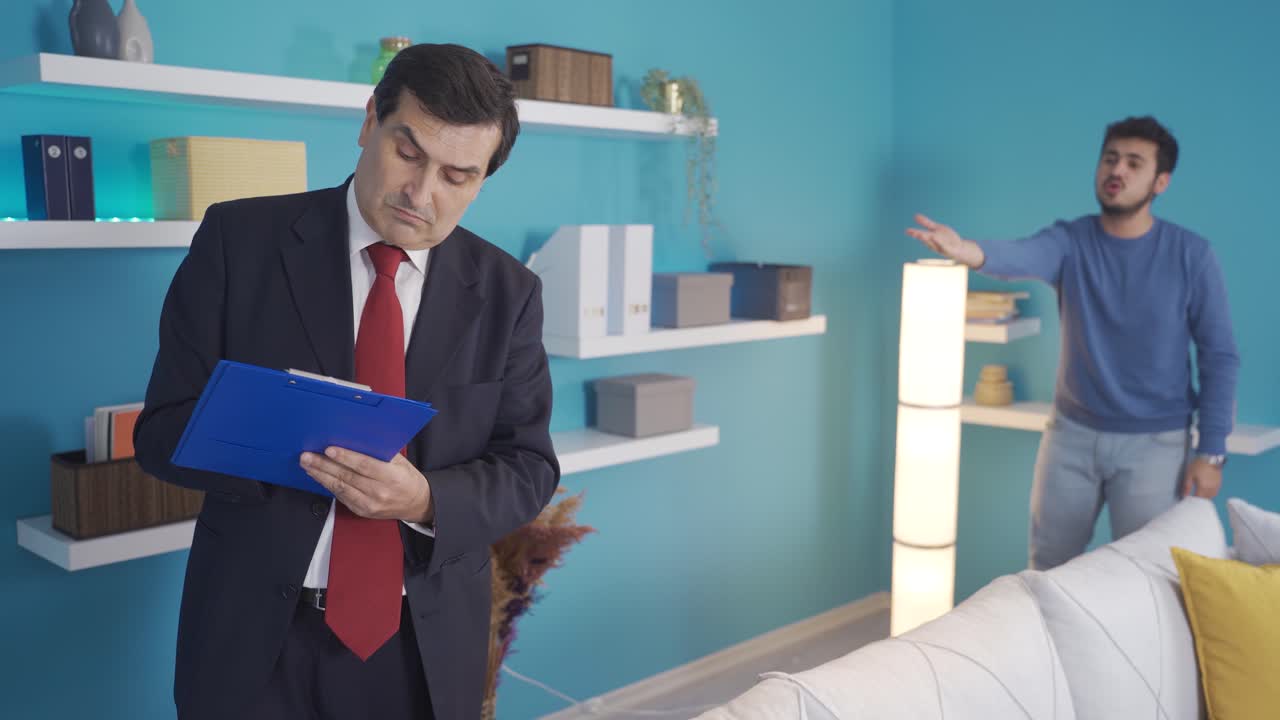 The debtor student's house is foreclosed and the young man is angry with the lien officer.