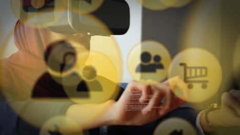 Multiple-yellow-digital-icons-floating-against-businesswoman-in-hijab-wearing-vr-headset-at-office