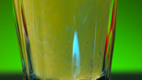 close-up of a drink being poured into a glass