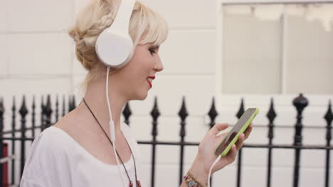 beautiful blonde listening to music in the city