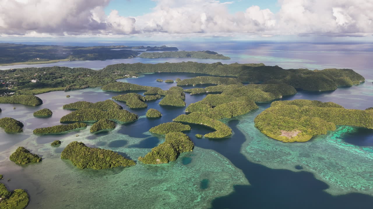 Epic cinematic drone shot sweeping across the crystal blue waters and islands of Palau. Revealing orbiting aerial drone shot