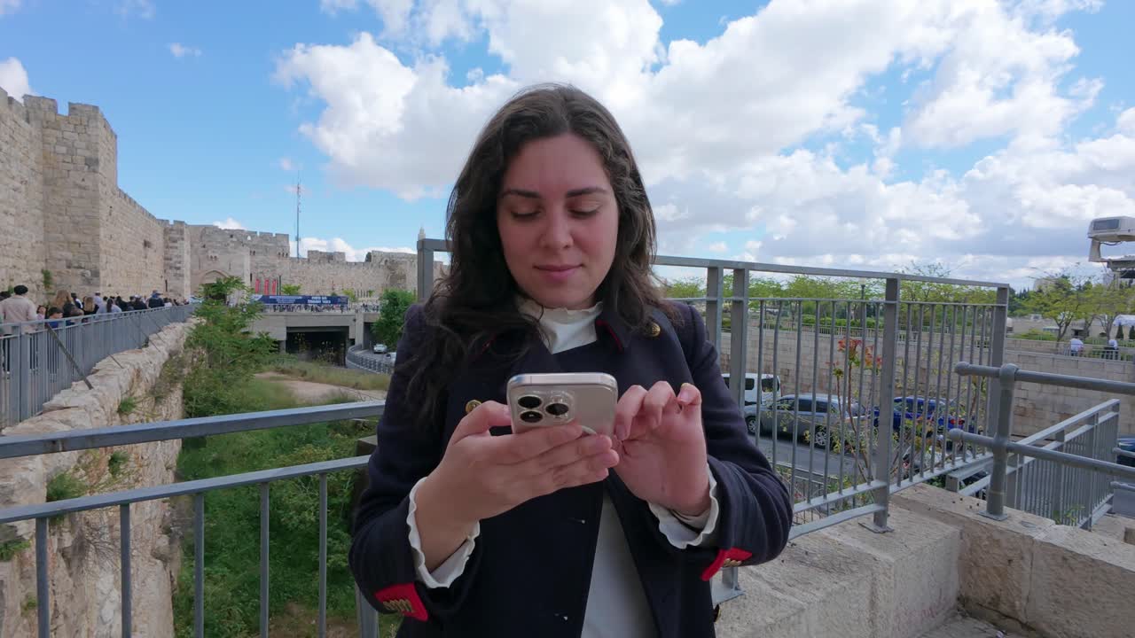 Woman Messaging on Phone While Visiting Jerusalem. Slow motion.